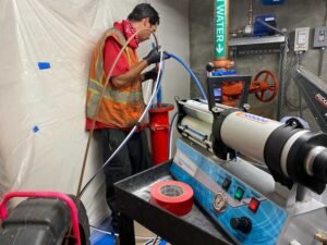 Clogged pipe being cleaned via hydro jetting